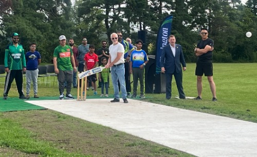 Clarington Mayor Adrian Foster batting at the grand opening of Clarington’s first municipal cricket pitch.