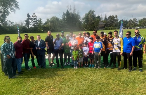 Clarington Mayor Adrian Foster (centre) invited Council members and local cricket clubs to join him in cutting the ribbon to open Clarington’s first municipal cricket pitch.