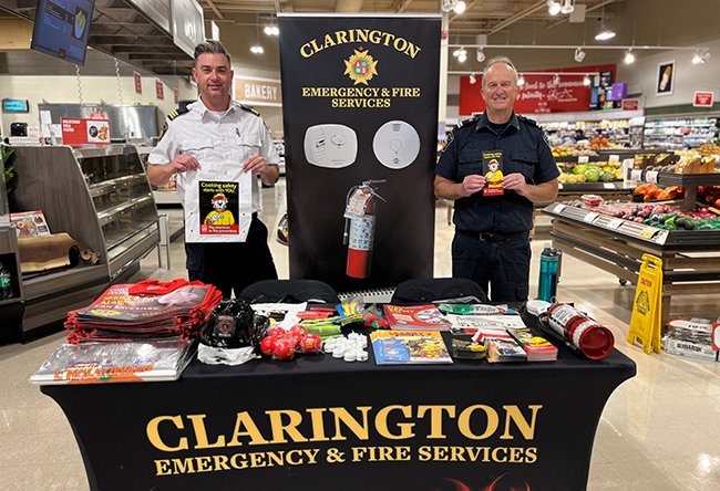 Matt Muirhead, Chief Fire Prevention Officer, and Jeff Norris, Fire Prevention Officer, share information with residents about fire prevention at Foodland in Newcastle. 