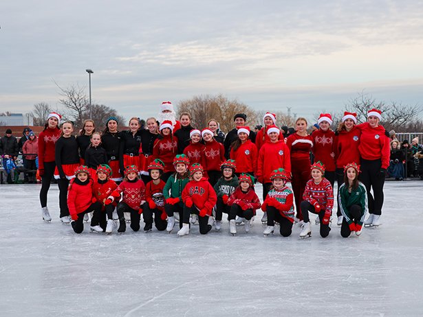 Orono Figure Skating Club gather on the ice surface for a photo.