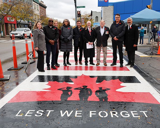 Piper Rick Paterson leads local veterans and Legion members across the crosswalk.