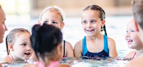 Kids in the pool during swimming lessons.