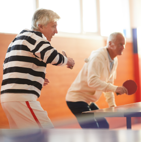Older adults playing table tennis.