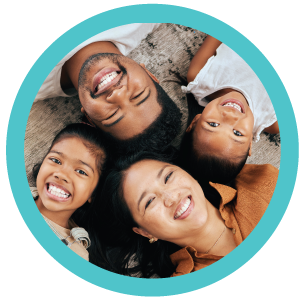 Happy family lying with their heads together in a ciricle.