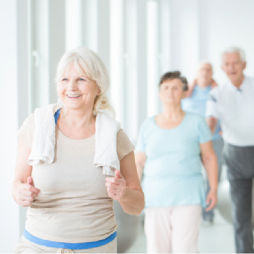 Group of seniors walking indoors.