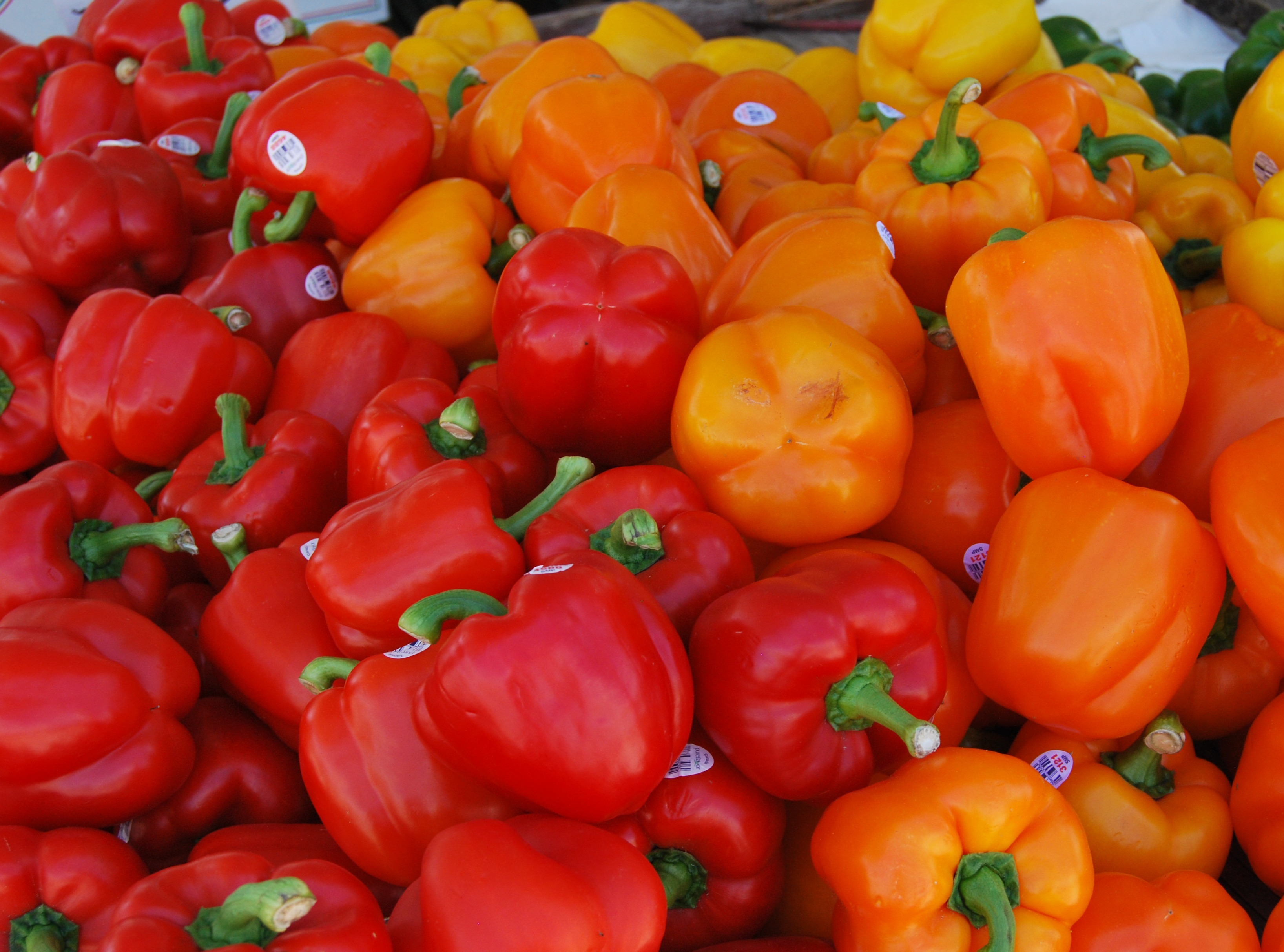 Red and orange peppers close up