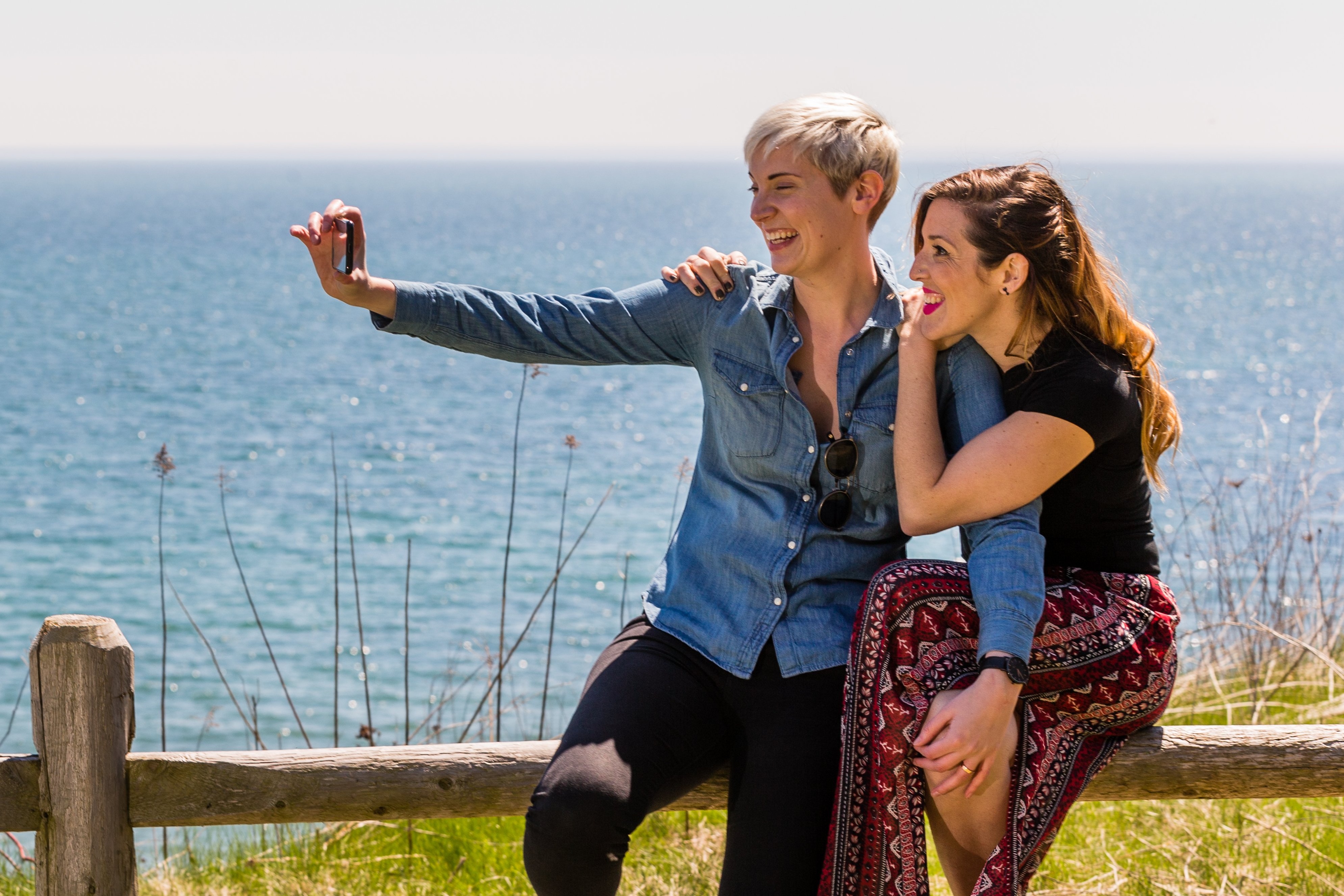 Couple taking photo in front of water