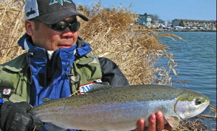 Man holding a fish he just caught.