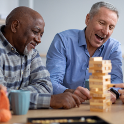 Two older adults playing board games.