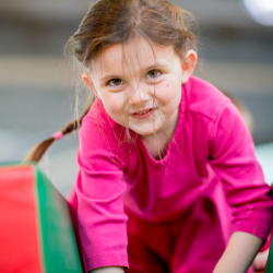 Preschool child playing on foam blocks