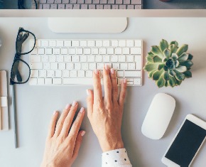 woman typing on a keyboard