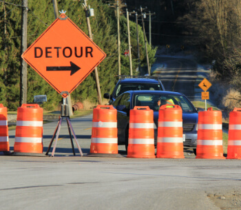 detour sign and pilons at a closed road