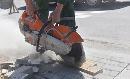 A person cutting a curb