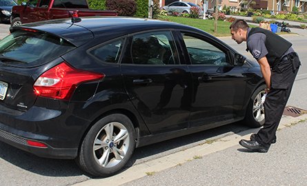 A by-law officer educating a driver