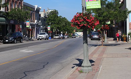 A road and sidewalk in downtown Bowmanville