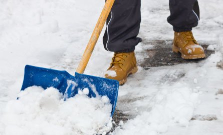 Clearing snow with shovel after storm.