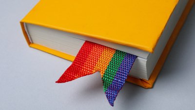 Yellow book with a rainbow pride book mark
