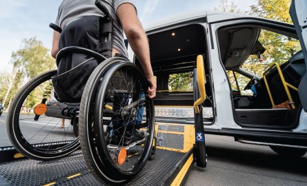 A man in a wheelchair getting into an accessible van.