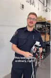 Firefighter holding an extension cord with many things plugged into it.