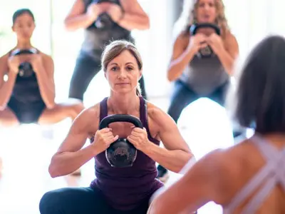 Group fitness class lifting kettlebells.