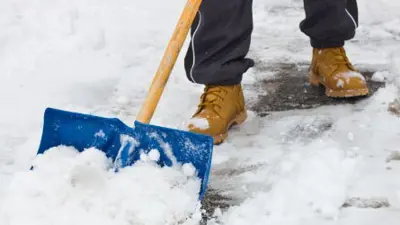 Clearing snow with shovel after storm.