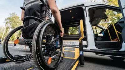A man in a wheelchair getting into an accessible van.