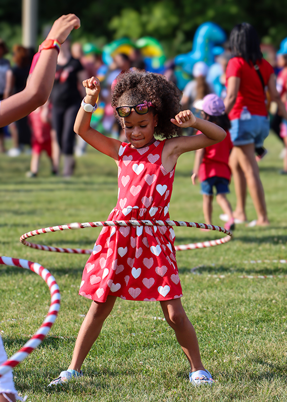 A young girl hula hoops