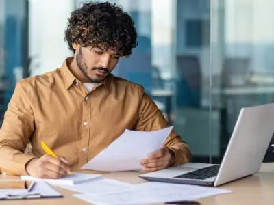 Hispanic man review paperwork.