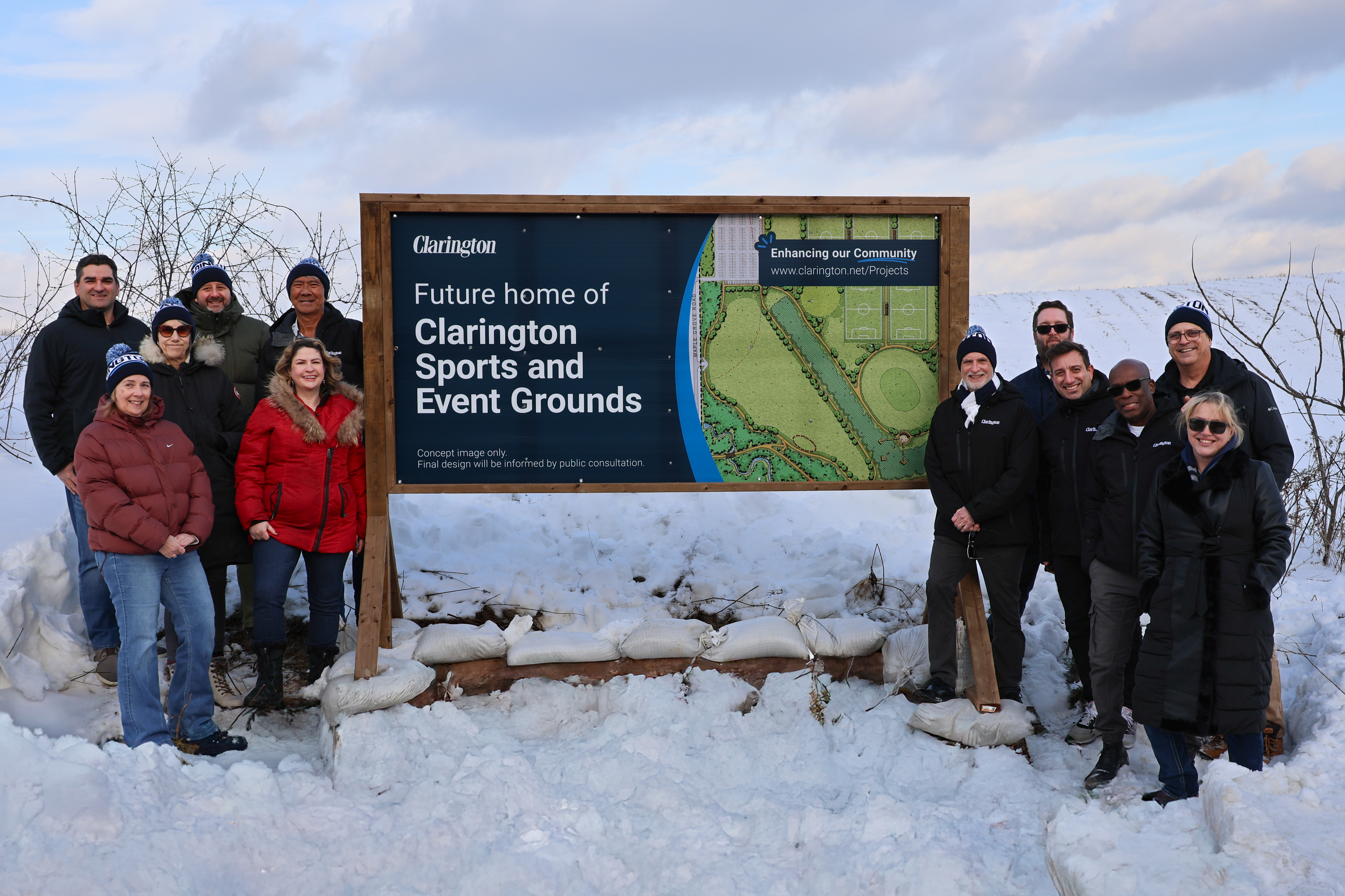 Mayor Foster, Members of Council, and Clarington staff beside the 'Future home of Clarington Sports and Event Grounds' sign.