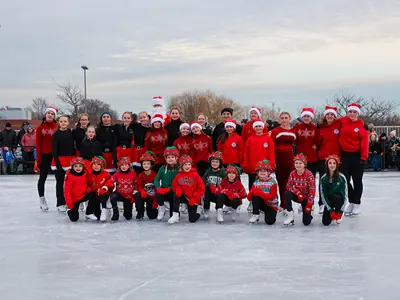Orono Figure Skating Club gather on the ice surface for a photo.