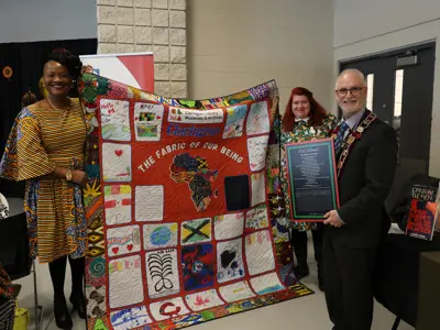 Nadine Williams holds community-led quilting project with Donnalee Smith of the Clarington Library, Museums and Archives, alongside Clarington Mayor Adrian Foster.